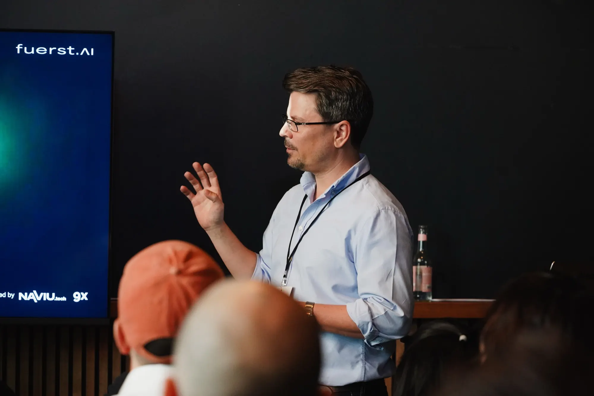 Florian Fürst explaining a use case to the audience at Berlin AI Day 2026